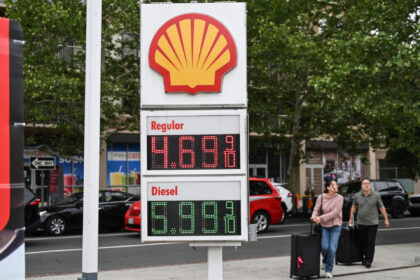 A sign displays the prices of unleaded gasoline and diesel fuel at a Shell gas station in
