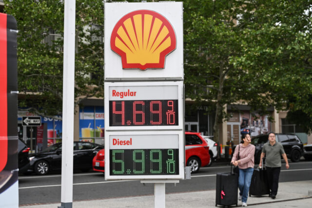 A sign displays the prices of unleaded gasoline and diesel fuel at a Shell gas station in