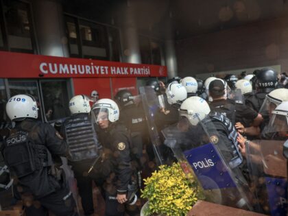 Turkish riot police officers try to enter the Republican People's Party (CHP) headquarters
