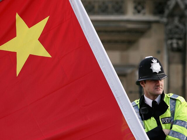LONDON - NOVEMBER 09: A policeman stands by a large Chinese flag as President Hu Jintao ar