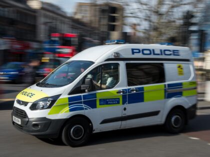 LONDON, ENGLAND - APRIL 07: A police vehicle drives through the centre of Brixton, as extr