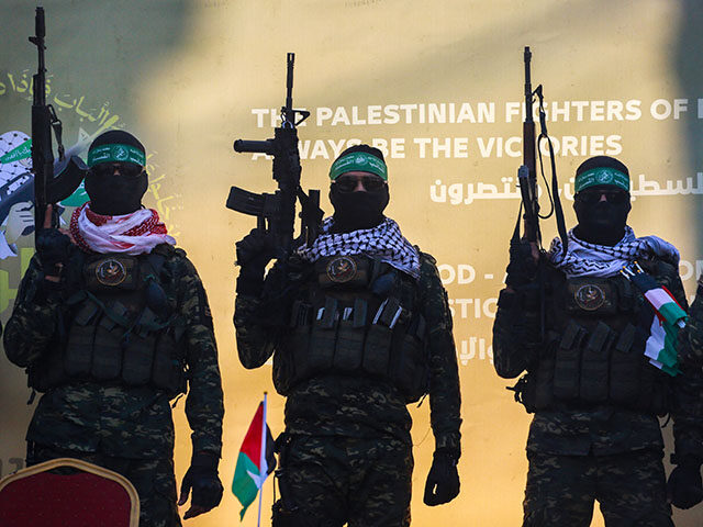 Hamas militants stand on a stage before releasing Isreali hostage Agam Berger to a Red Cro
