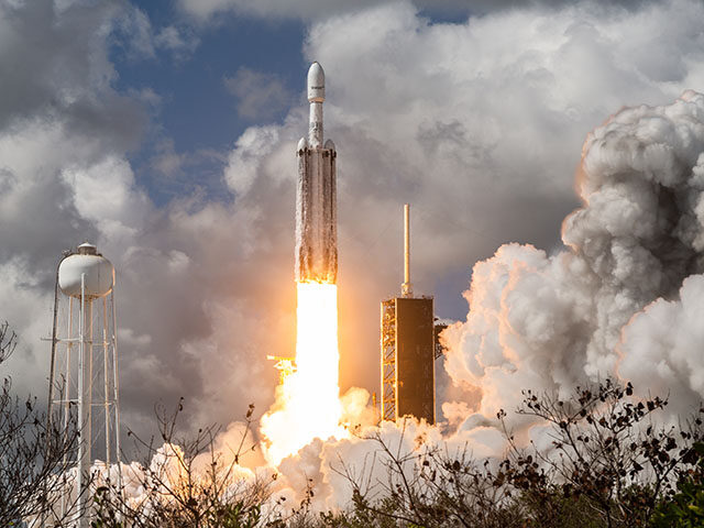 SpaceX Falcon Heavy rocket lifts off from launch pad 39A at the Kennedy Space Center, carr