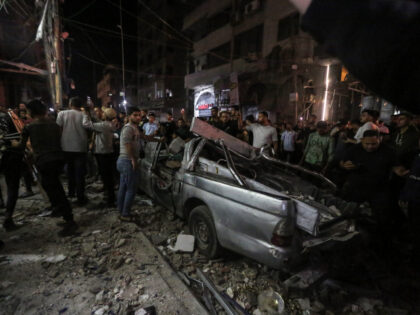 mergency teams arrived at the scene following Israeli airstrikes on a residential building