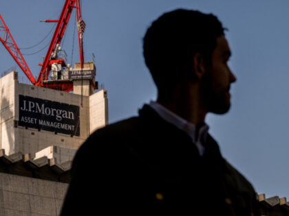 A banner with the JP Morgan Asset Management logo on the redevelopment site of 65 Gresham