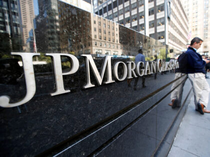 A man pauses outside one of two JPMorgan Chase & Co. buildings on Park Avenue in midtown M