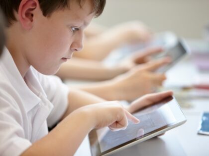 Kid studying on tablet