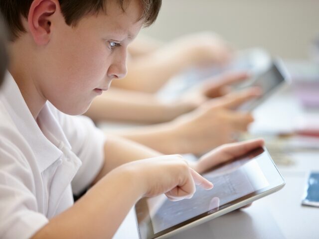 Kid studying on tablet
