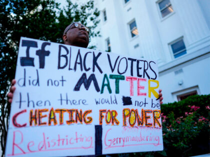 Travis Jackson, of Montgomery, stands during a press conference outside the Alabama state