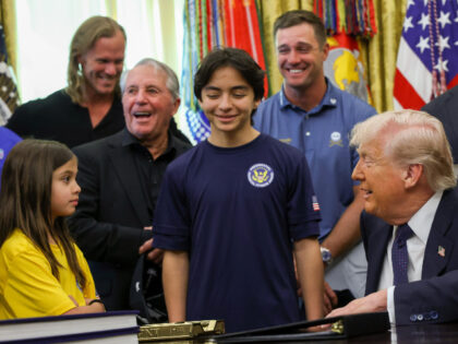 U.S. President Donald Trump speaks to young athletes as he is joined by (L-R) MLB pitcher
