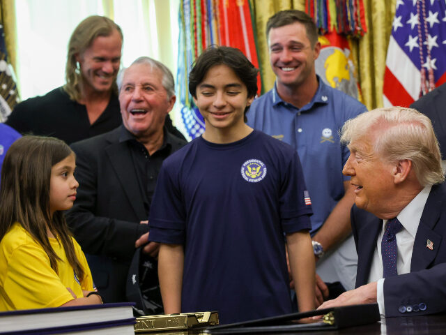 U.S. President Donald Trump speaks to young athletes as he is joined by (L-R) MLB pitcher