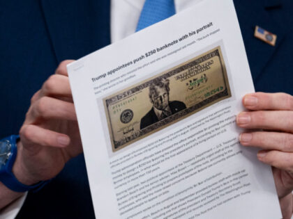 US Secretary of Treasury Scott Bessent shows a proposed $250 bill featuring President Dona
