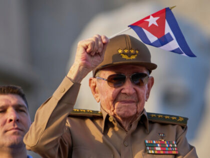 Raul Castro waves a Cuban national flag while attending the May Day parade at Revolution S