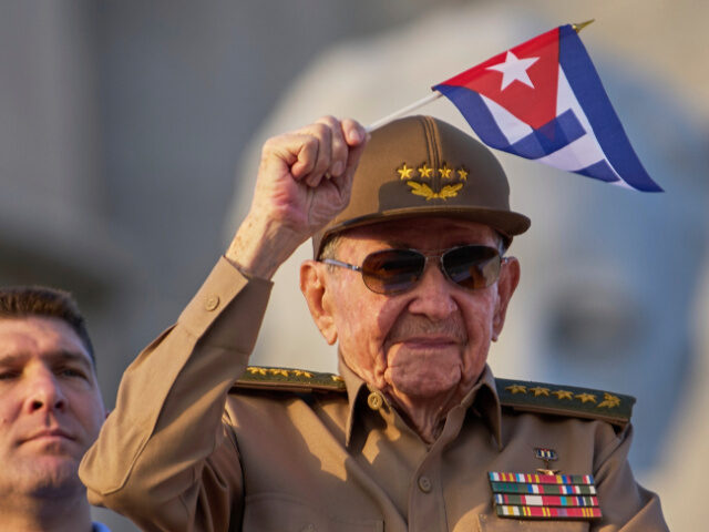 Raul Castro waves a Cuban national flag while attending the May Day parade at Revolution S