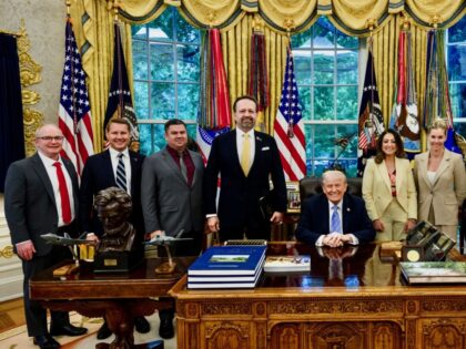 President Donald J. Trump signs an Executive Order and poses for photos with guests alongs