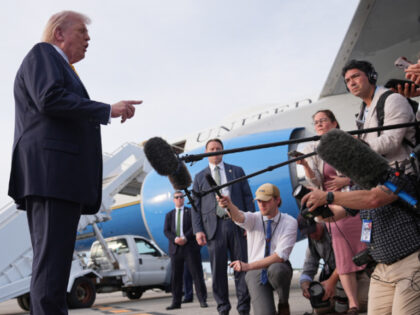 President Donald Trump talks to reporters before he boards Air Force One at Palm Beach Int