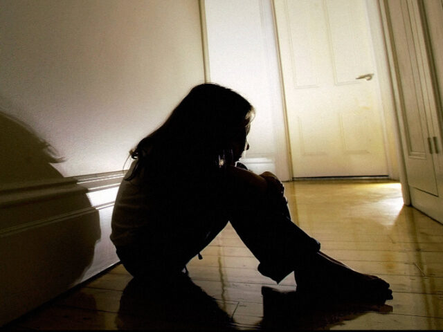 abused child in hallway A child sits in the hallway of a house, 30 August 2005. THE AGE Picture by JOHN DONEGAN (P