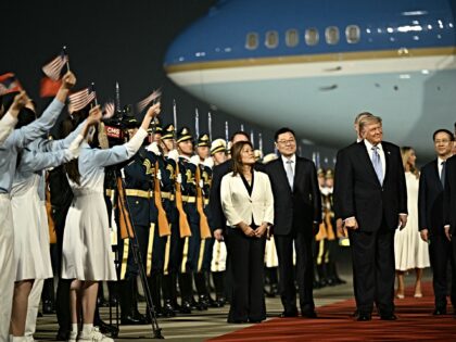 US President Donald Trump (C) is escorted by China's Vice President Han Zheng (R) upon his