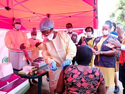 A health worker prepares to administer a trial dose of ebola vaccine during a vaccination