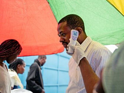 A visitor at the CBCA Virunga hospital has his temperature checked at a screening checkpoi