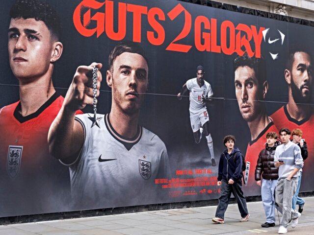 People out near Oxford Street interract with a large scale hoarding which features England