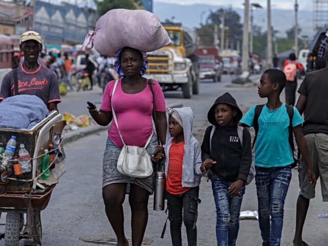 haiti upheaval PORT-AU-PRINCE, HAITI - MAY 11: Residents flee their homes to escape clashes between armed