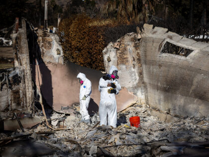 Altadena, CA - January 21: Wearing protective gear, Eaton fire victims and neighbors Kara