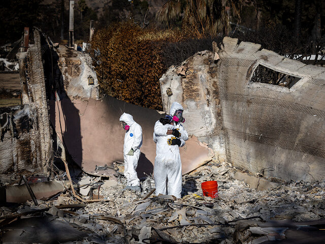 Altadena, CA - January 21: Wearing protective gear, Eaton fire victims and neighbors Kara