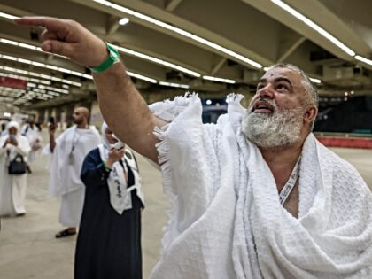 A Muslim pilgrim performs the symbolic 'stoning of the devil' ritual as part of the Hajj p