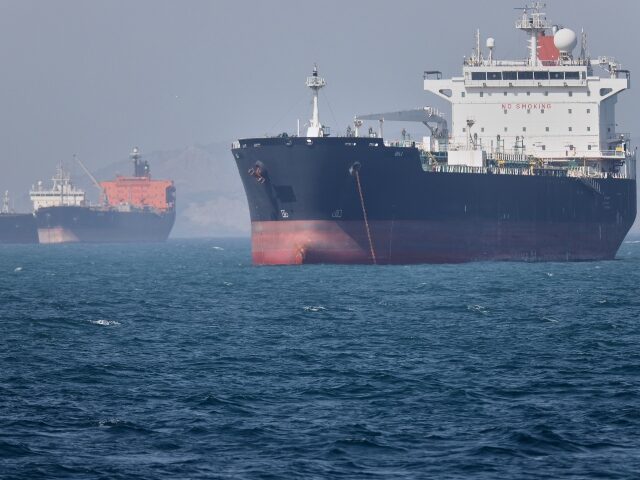 Oil tankers sit at anchor offshore in the Strait of Hormuz off Bandar Abbas, Iran, Saturda