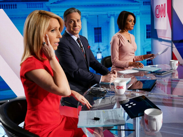 CNN news anchor Jake Tapper (C), flanked by Univision's news anchor Ilia Calderón (R