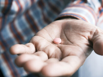 man holding pill