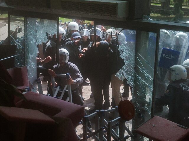 ANKARA, TURKEY - MAY 24: Riot police fire tear gas as they break the entrance door of the