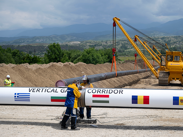 Workers weld a pipe at the construction site of the Vertical Gas Corridor, connecting Gree