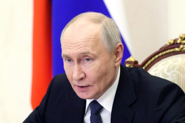 In this pool photograph distributed by the Russian state agency Sputnik, Russia's Pre