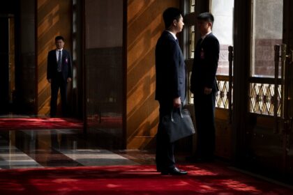 Chinese security wait inside the Great Hall of the People for US President Donald J. Trump
