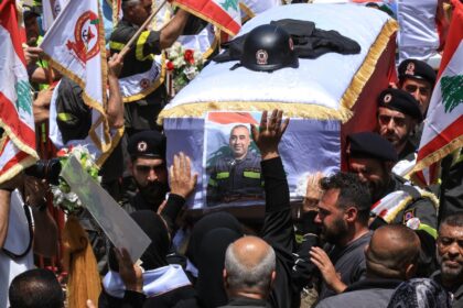 Fellow rescuers carry the coffins of two members of the civil defence who Lebanon said wer