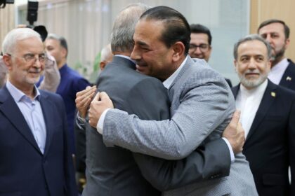 In this handout from Iran's presidency, President Masoud Pezeshkian (C-L) embraces Pa