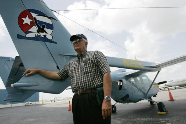 Jose Basulto, founder of the Cuban exile group Brothers to the Rescue, stands next to a pl