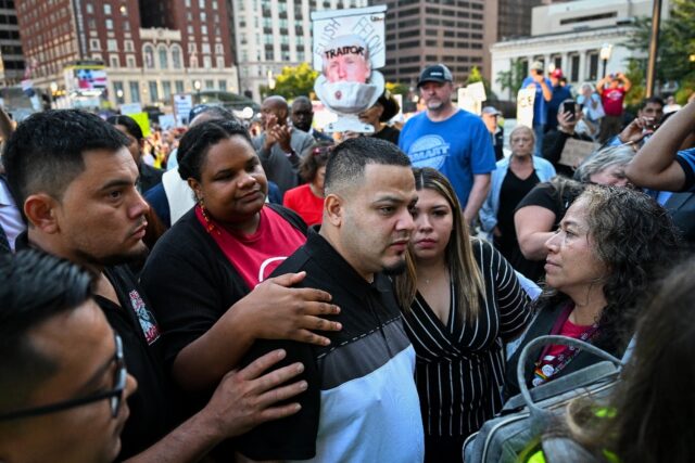 A judge dismissed criminal charges against Kilmar Abrego Garcia (C), who is at the center