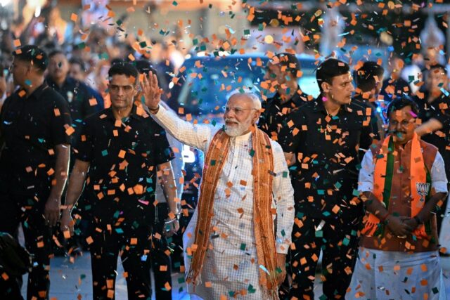 Prime Minister Narendra Modi waves to supporters at BJP party headquarters in New Delhi