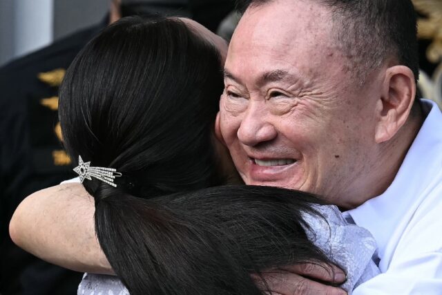 Thaksin Shinawatra hugs his daughter Paetongtarn at Klong Prem Central Prison in Bangkok