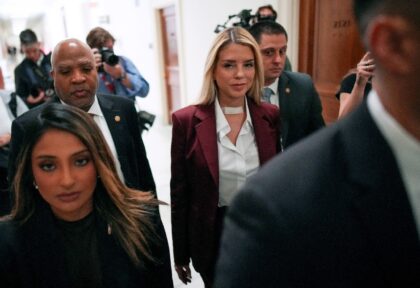 Former US Attorney General Pam Bondi (C) arrives to testify at a closed-door interview wit