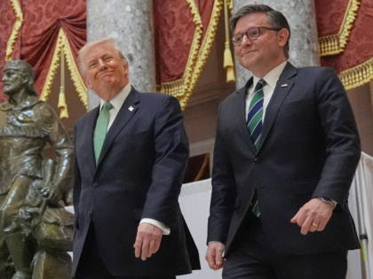 President Donald Trump walks through Statuary Hall with House Speaker Mike Johnson of La.,