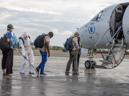 Title: Congo Ebola Image ID: 26153601905945 Article: A health worker disinfects passengers