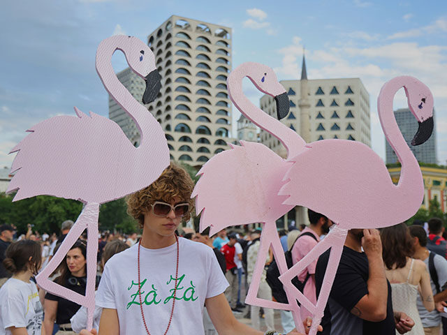 Title: Albania Protest Kushner Image ID: 26154616038805 Article: Protesters hold pink flam