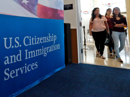FILE - In this Aug. 17, 2018, file photo, people arrive before the start of a naturalizati
