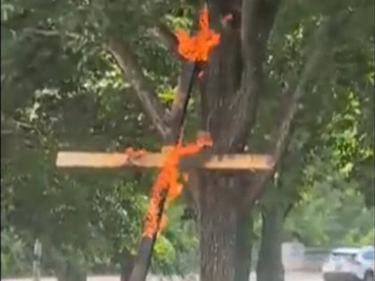 This framegrab from a video taken by motorist Keinika Carlton shows a wooden cross engulfe