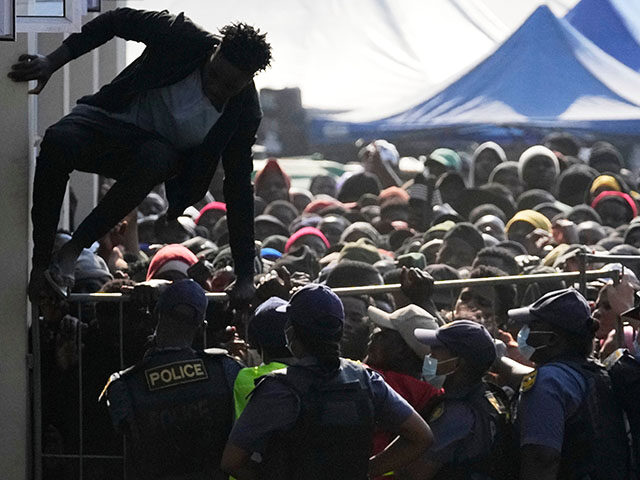 Title: South Africa Migrants Image ID: 26169493955998 Article: A Malawian migrant jumps ov
