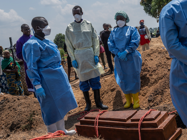 Red Cross workers prepare to bury Vanisa Anifa, a 6-month-old orphaned girl who died of Eb